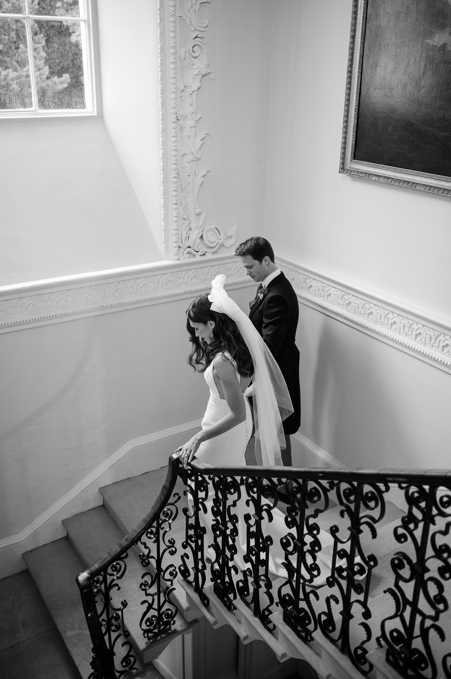 The bride and groom on the staircase at a Came House wedding by Sophia Veres Photography.